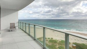 A balcony with a view of the beach and ocean. - Condo at Amrit Ocean Resort w/ Panoramic Views (Singer Island)