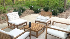An outdoor seating area with wooden furniture and cushions. - Zutendaal Forest Retreat (Zutendaal)