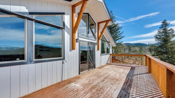 A wooden deck with a view of mountains, a balcony with wooden railings, and large windows. - Pristine Cabin w/ Stables in Black Hawk by Casinos (Black Hawk)