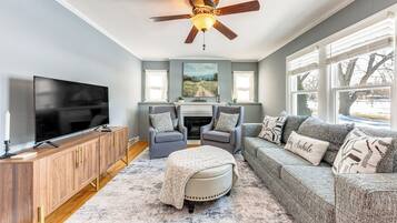 House (1 Bedroom) | Living area | TV, fireplace, books