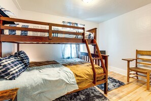 A bunk bed with a ladder, a chair, and a rug in a room with wooden flooring and white walls. - 4 Mi to Lake Superior: Calumet Getaway! (Calumet)