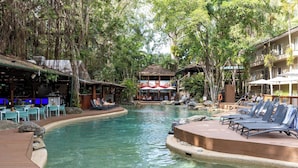 A pool area with lounge chairs, a bar, and a restaurant. - Cozy studio in gorgeous Port Douglas with WiFi, fitness room, AC (Port Douglas)