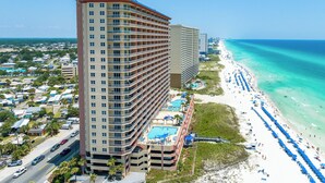 A high-rise hotel with multiple balconies, a pool area, and a beachside location. - Beachfront with unbeatable views, 3BR 2BA Condo at Sunrise Beach! (Panama City Beach)