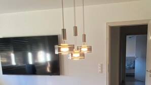 A modern kitchen with a large island, built-in appliances, and a contemporary pendant light fixture. - Wellness in the Eifel for Ages 16 and Up (Mechernich)