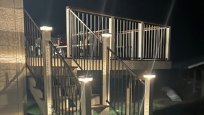 A staircase with a metal railing and lights, leading to an upper level. - Private, luxury, 4-bedroom home minutes from downtown Bigfork (Bigfork)