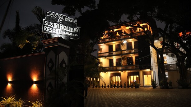 A multi-story building with a sign reading "Crystal Wave by Susiri Holiday Resort." - crystal wave (Matara)