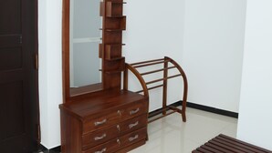 A room with a wooden dresser, a bench, and a mirror. - crystal wave (Matara)