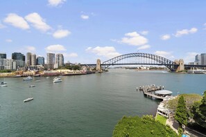 A cityscape with a prominent bridge, waterfront, and modern buildings. - Harbourside 43 Summar (McMahons Point)