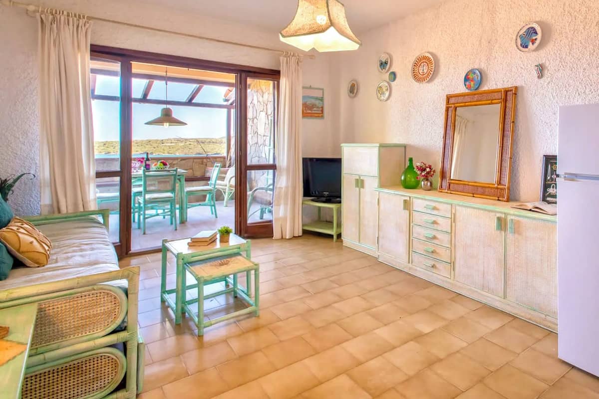 Apartment | Living area | 24-inch flat-screen TV with satellite channels