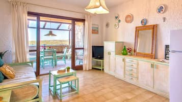 Apartment | Living area | 24-inch flat-screen TV with satellite channels