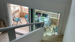 A staircase leading to a balcony with a view of the ocean. - T4 seafront apartment, magnificent view (Le Lavandou)