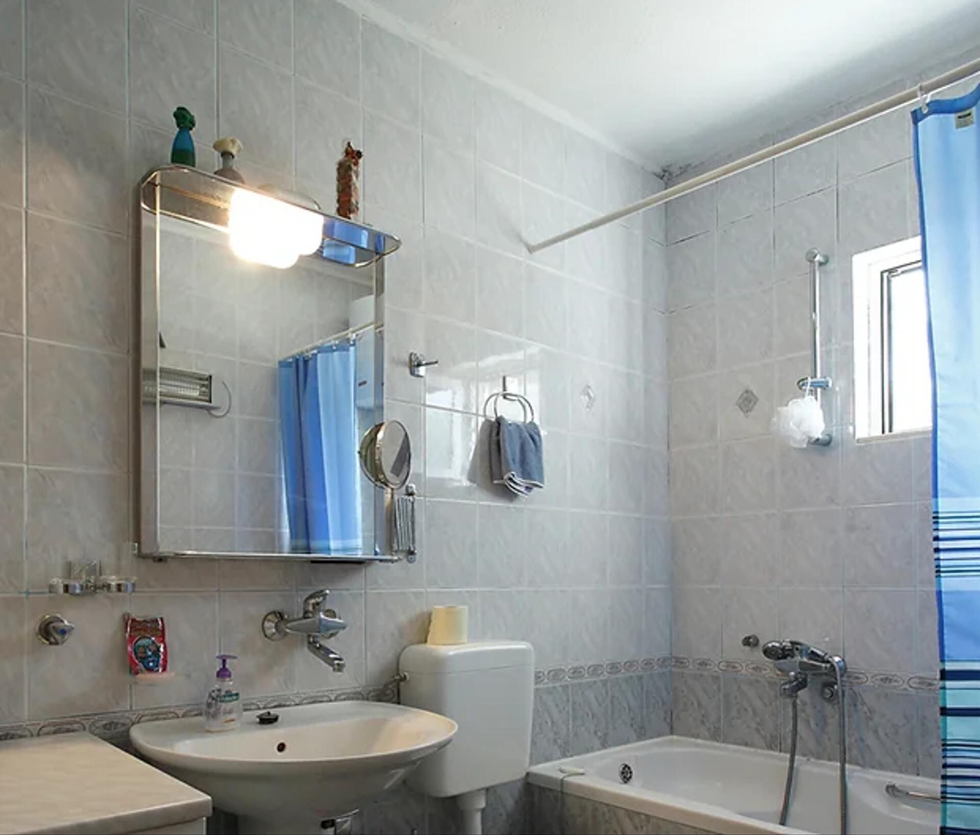 A bathroom with a sink, toilet, and bathtub.
