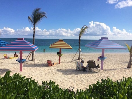 On the beach, sun-loungers, beach towels. Charming 2-bedroom Beach Access Condo in marvelous Freeport, Lucaya