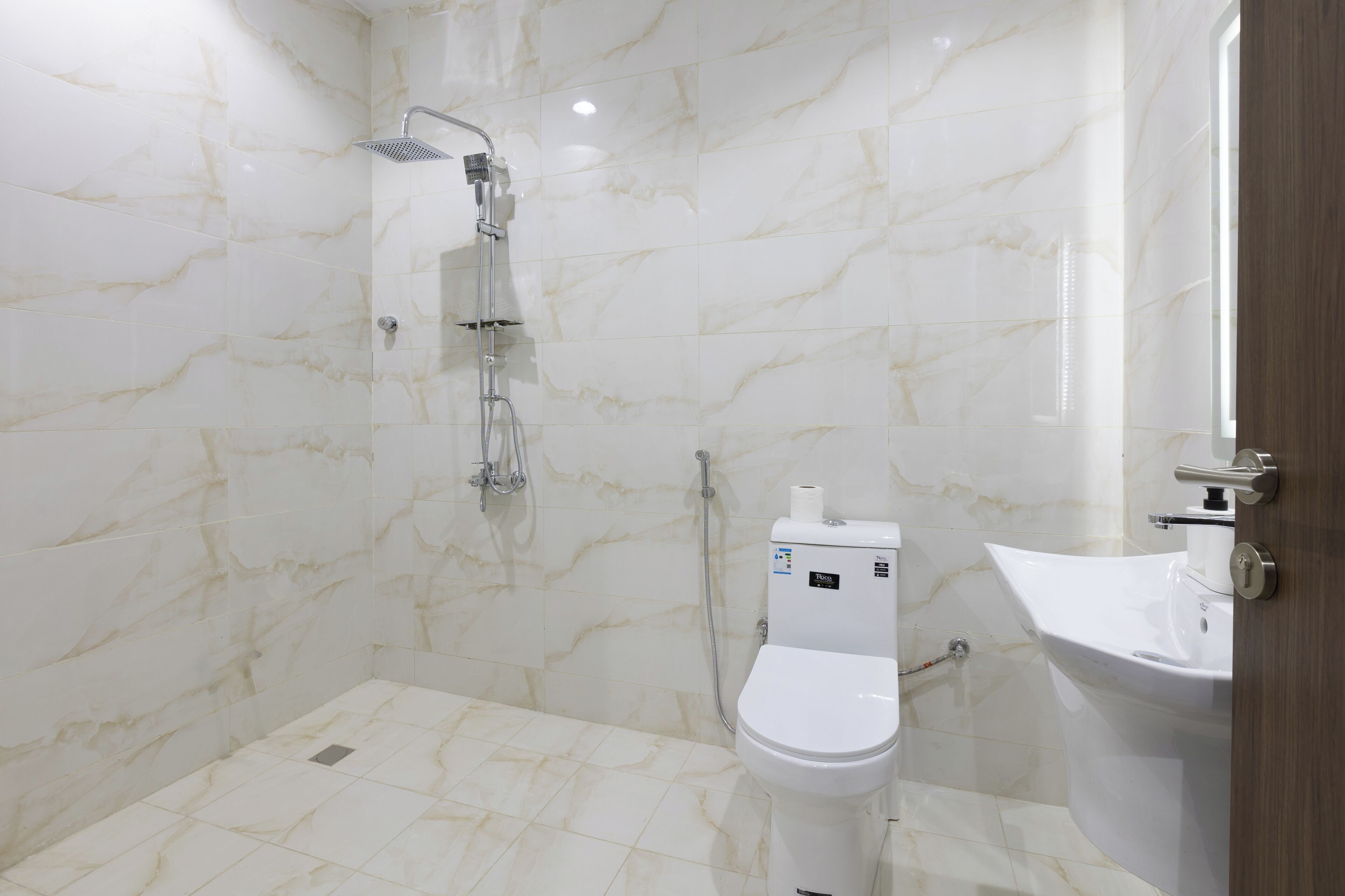 A bathroom with a shower, toilet, and sink.