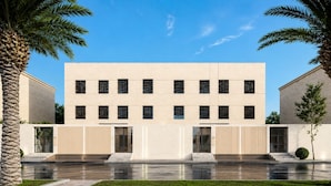 A modern building with a symmetrical facade, large windows, and a central entrance. - Al-Jamwaut B - Nozol Noor 7 (Madinah)