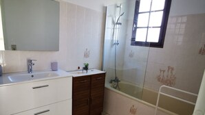 A modern bathroom with a white vanity, a glass shower enclosure, and a small window. - House Gure-Phauxagia (Gotein-Libarrenx)