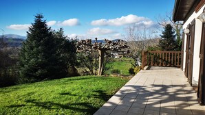 A patio area with a view of a green landscape and distant hills. - House Gure-Phauxagia (Gotein-Libarrenx)