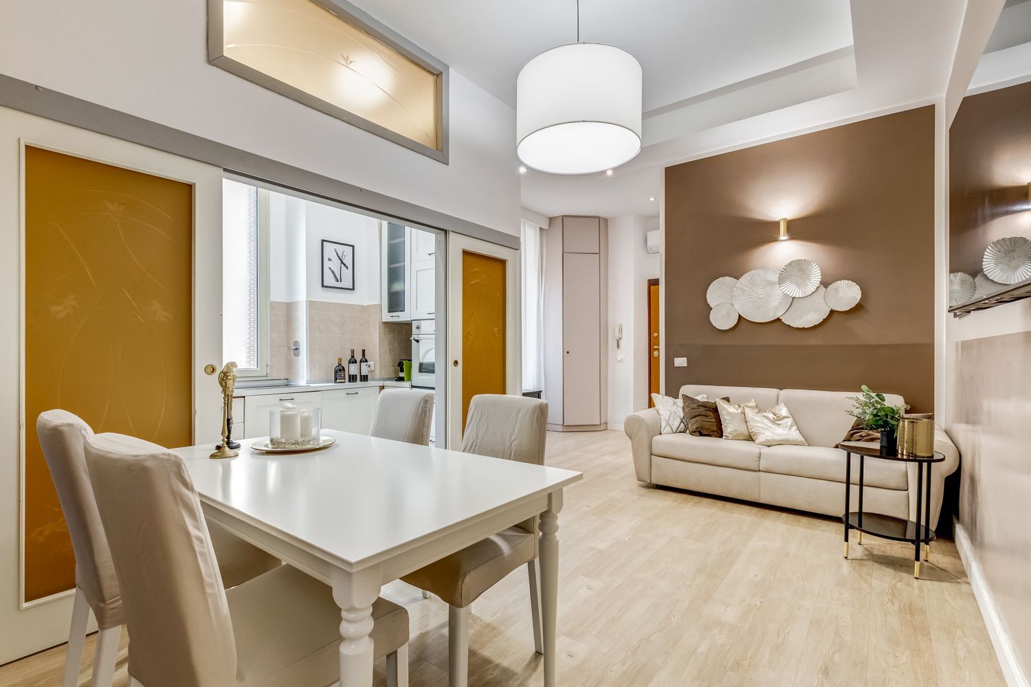 A modern living room with a dining area, a sofa, and a coffee table.
