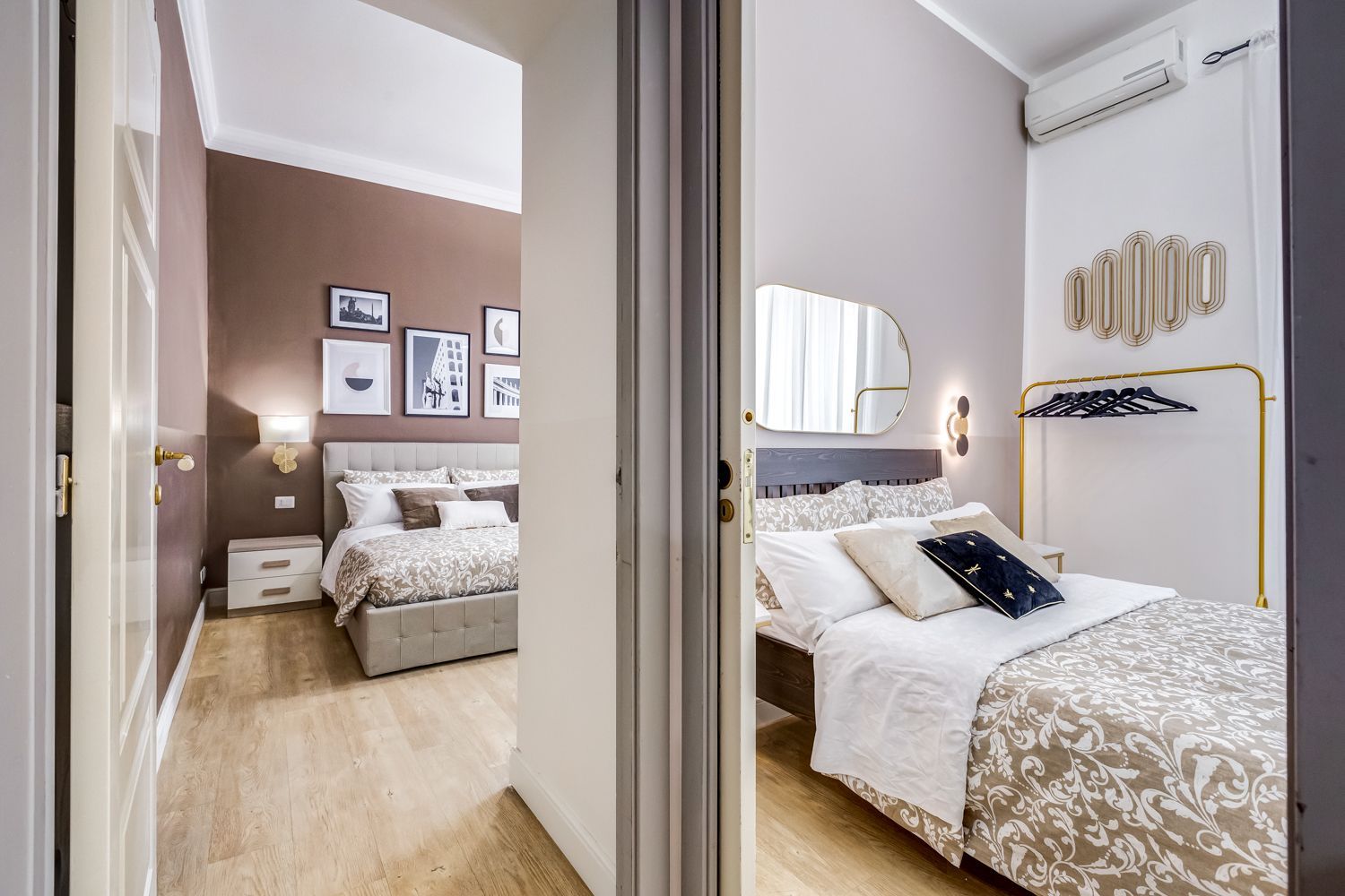 Una camera da letto con un letto, comodini, uno specchio e luci a parete.