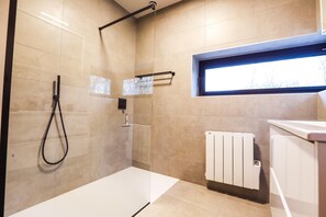 A modern bathroom with a glass-enclosed shower, a towel rack, a window, and a white radiator. - Elegant Stay Near Durbuy (Durbuy)