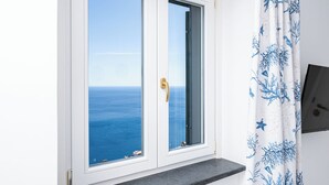 A room with a view of the sea through a window with a gold handle. - Van Gogh Room (Amalfi)