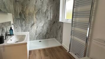 Shower, hair dryer, towels, soap