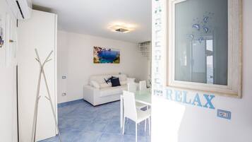 Signature Duplex, Balcony | Living area | 40-inch flat-screen TV with digital channels