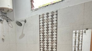 A bathroom with a toilet, bidet, and sink. - Hotel Tawa Plaza (Itarsi)