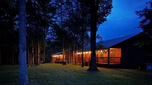 A wooden cabin with a porch and a deck, surrounded by trees. - Escape to the Farm- Minutes from Dale Hollow Lake! (Alpine)