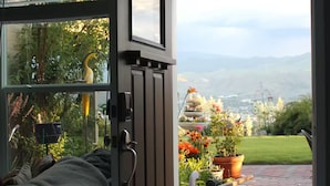 A room with a sliding glass door leading to a garden.