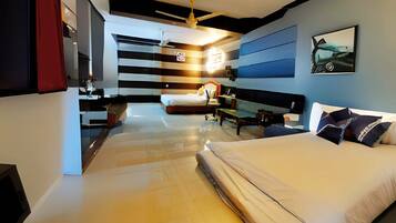 A modern hotel room with two beds, a ceiling fan, a flat-screen TV, and a large window.