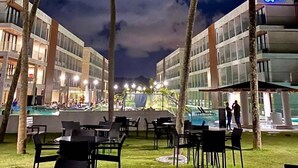 A resort with a pool area, palm trees, and outdoor seating. - Gav Porto Alto Resorts (Ipojuca)