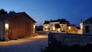 A rustic building with a wooden exterior and a stone wall in the foreground.