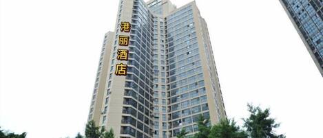A tall hotel building with multiple floors and a modern architectural design.