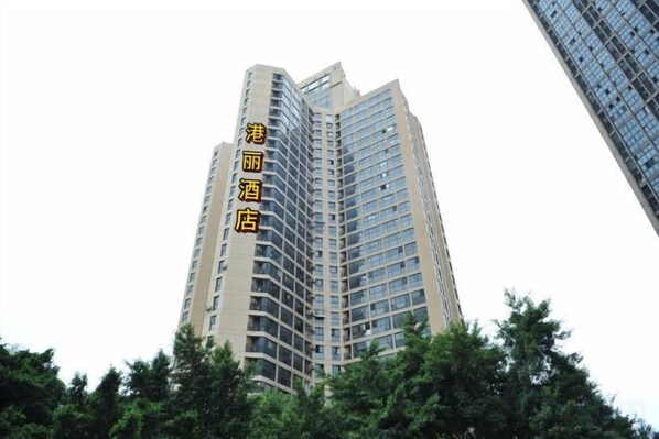 A tall hotel building with multiple floors and a modern architectural design.