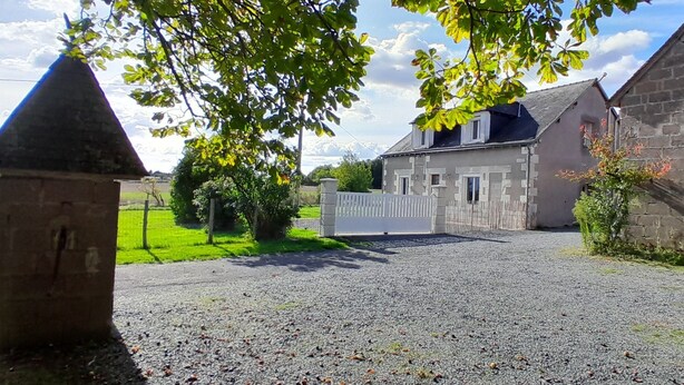 A gravel driveway leading to a stone building with a white fence. - Le Paradis near Beauval. (Orbigny)