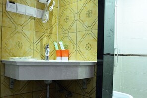 A bathroom with a sink, a mirror, and a towel rack.