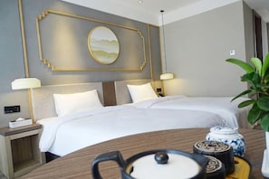 A hotel room with a large bed, bedside tables, lamps, and a decorative wall piece. - Fairyland Premium Hotel (Kunming Tuodong Sports Center Tangzixiang Metro Station) (Kunming)