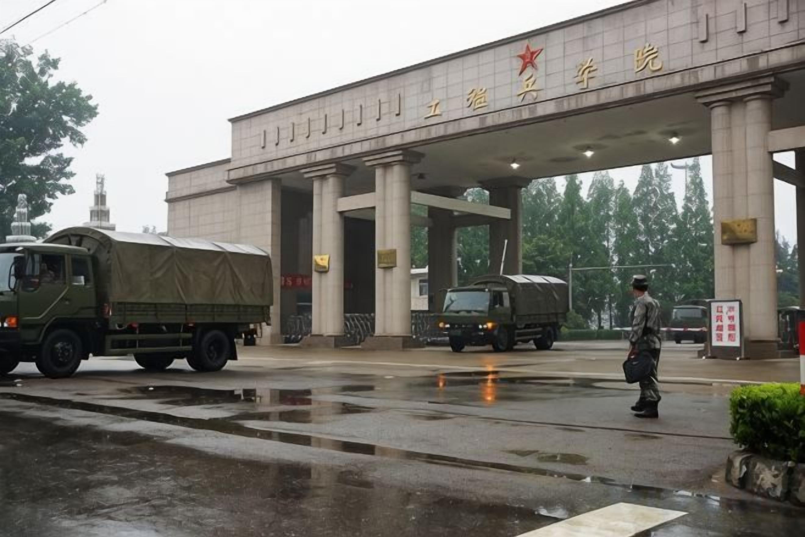 A military checkpoint with a large building and a guard.