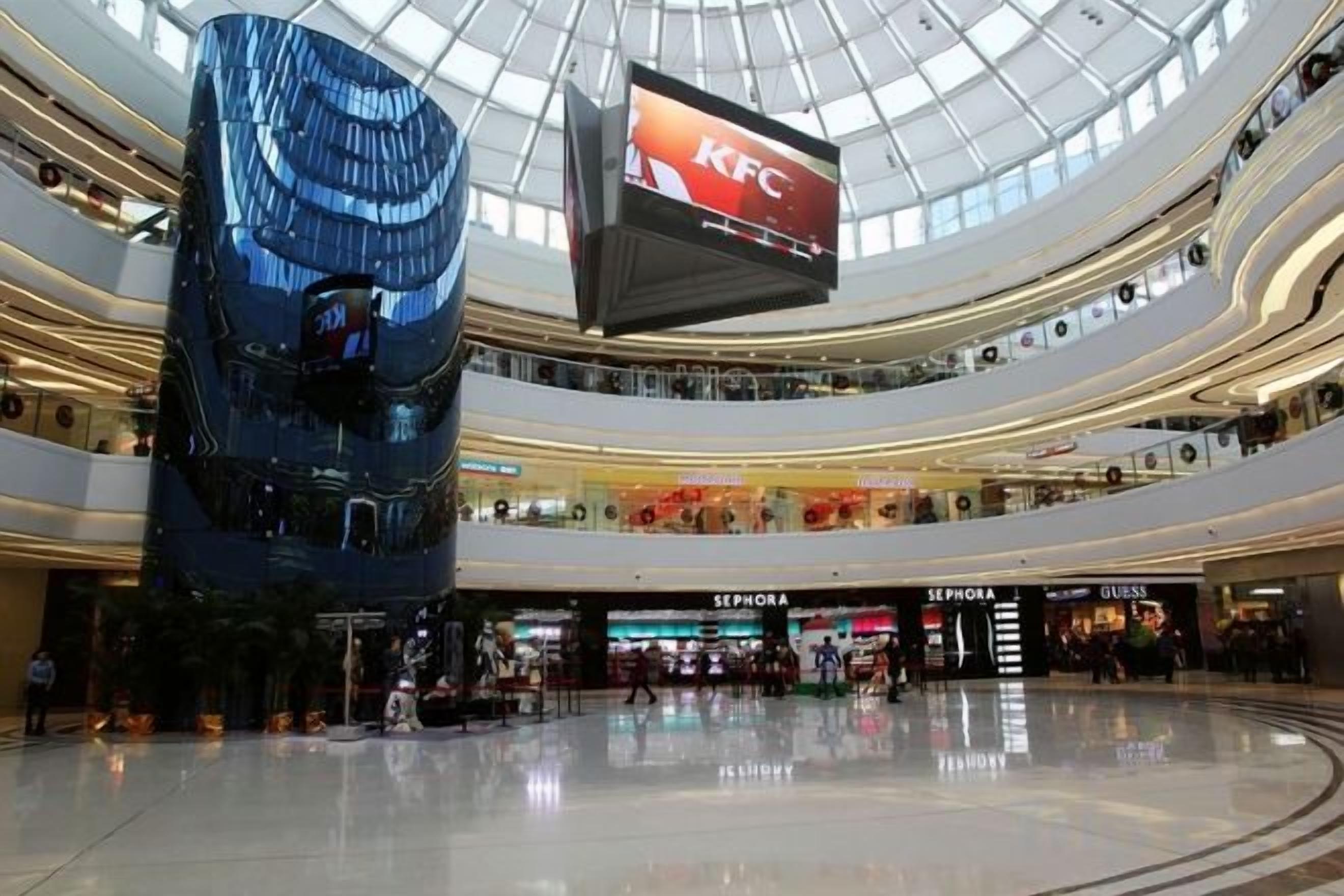 A multi-level shopping mall with a KFC sign, Sephora, and Gucci stores.