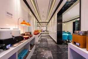 A hotel corridor with a reception desk, seating area, and a long counter with amenities. - Xana Hotelle (Shenzhen Luohu Dongmen Yitian Holiday Plaza Hotel） (Shenzhen)