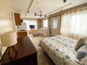 A bedroom with a bed, a desk, a chair, a television, and a ceiling fan. - Surfside 3 bedroom townhome 1 block to BEACH (Old Orchard Beach)