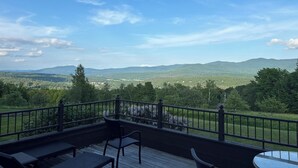 A deck with a view of a mountainous landscape.