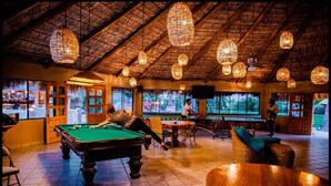 A pool table in a room with a thatched roof and hanging light fixtures. - 1 Bdrm, 2 Baths!!!! This is a larger 2 bdrm, chng'd to a 1 Bdrm!   MUCH LARGER!! (Cabo San Lucas)