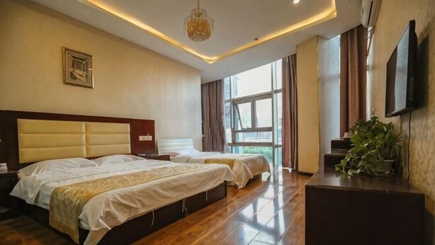 A hotel room with two beds, a flat-screen TV, a large window, and a wooden floor. - Super 8 (Beijing Yizhuang Kechuang Jiujie) (Beijing)