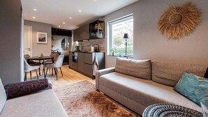 A compact living space with a kitchenette, a dining area, and a sofa. - Gorgeous apartment in Helsingborg with WiFi (Helsingborg)