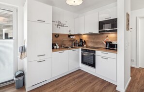 Fridge, stovetop, dishwasher, coffee/tea maker