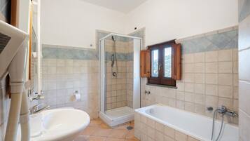 A bathroom with a shower, a sink, and a bathtub.