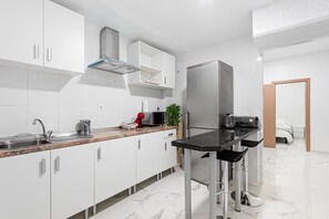 Fridge, microwave, stovetop, coffee/tea maker