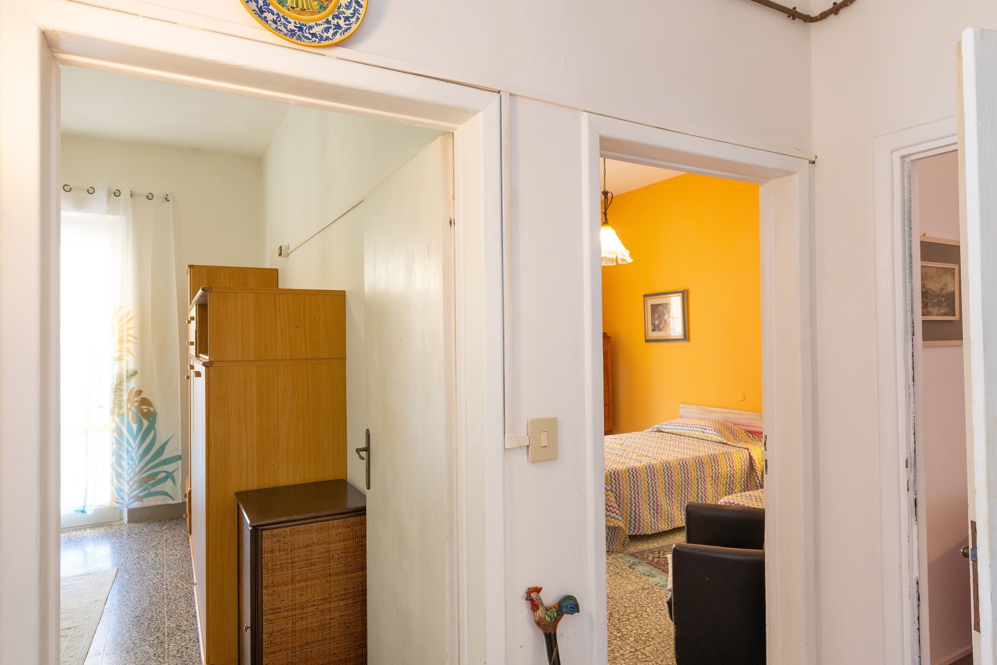 Een kamer met een bed, een stoel en een houten kast.